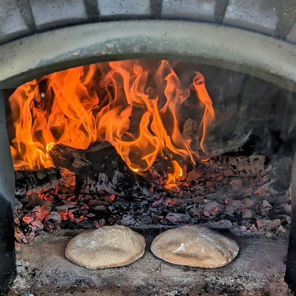 Sourdough whole grain pitas puffing up in the oven