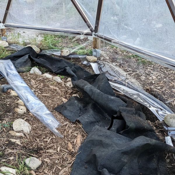 Replaced the bottom of the greenhouse cover with the same plastic that the rest of the cover is made from