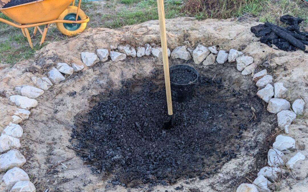 Crushing and hauling biochar out of the pit.
