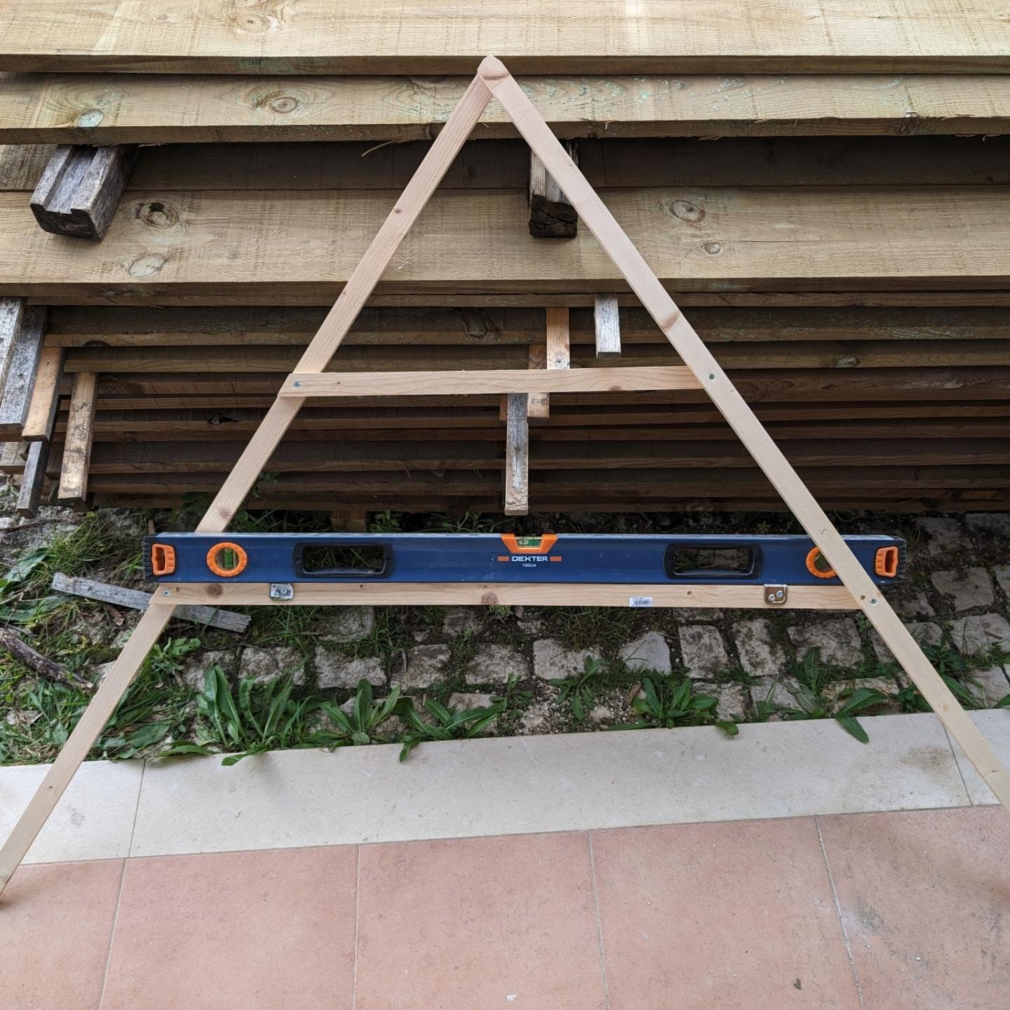 Made an A-frame level and used it to mark the location of a mini swale on top of the playground.