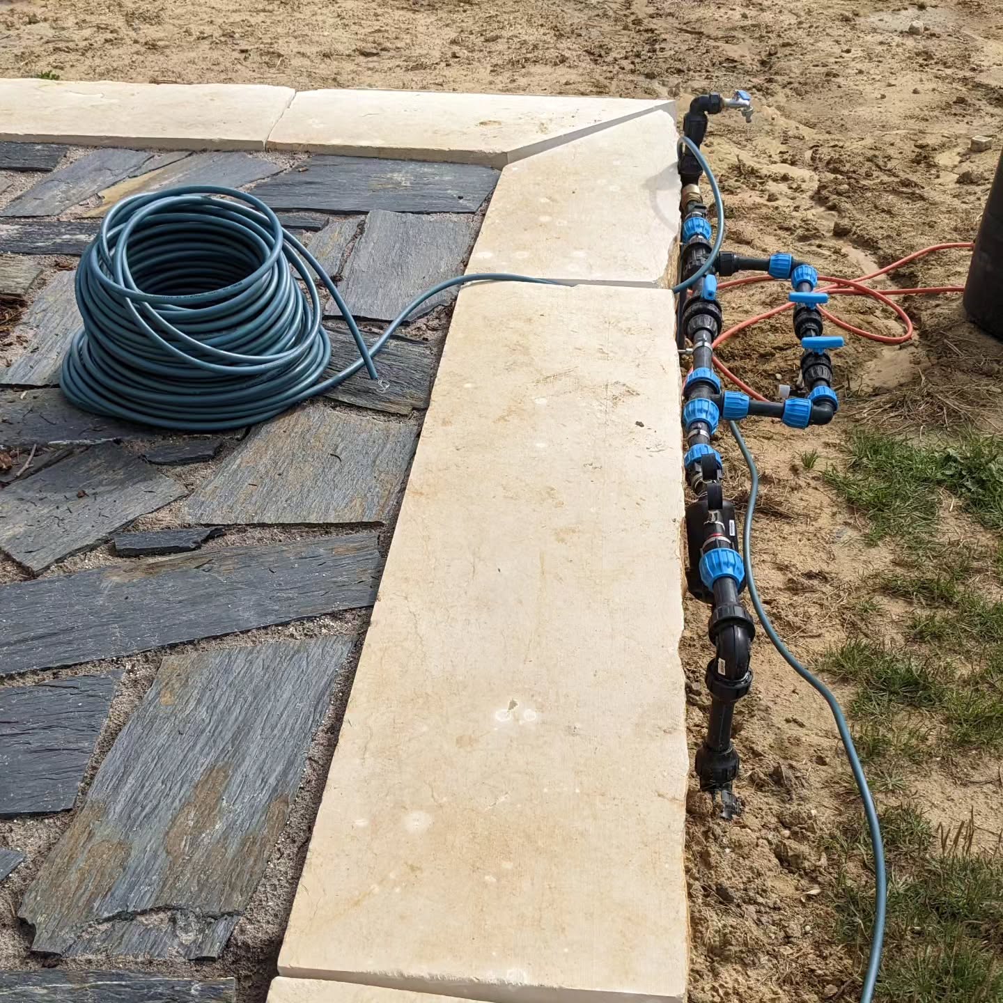 Burying tube to and through the terrace for wiring up it’s irrigation valve.