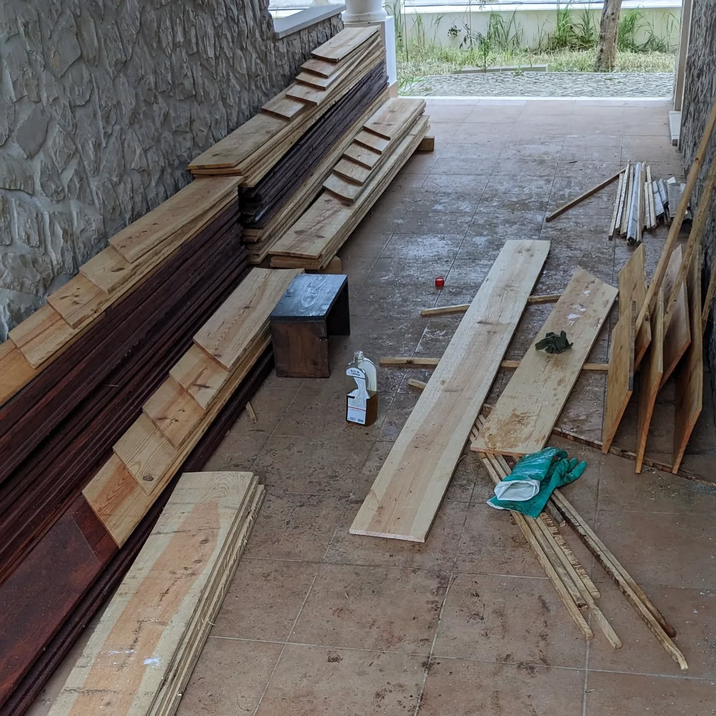 Applying linseed oil to planks for the new duck coop walls.