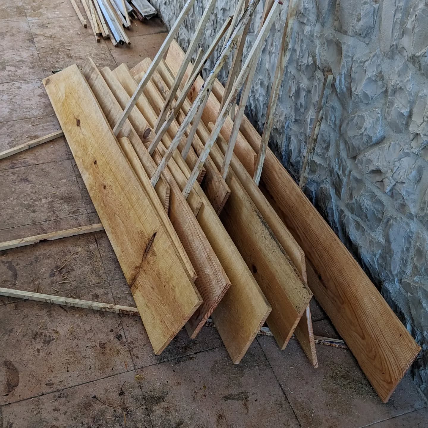 Applying linseed oil to planks that will cover the duck coop walls.