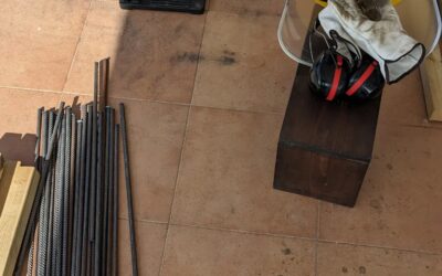 Cutting even more rebar stakes for garden beds.