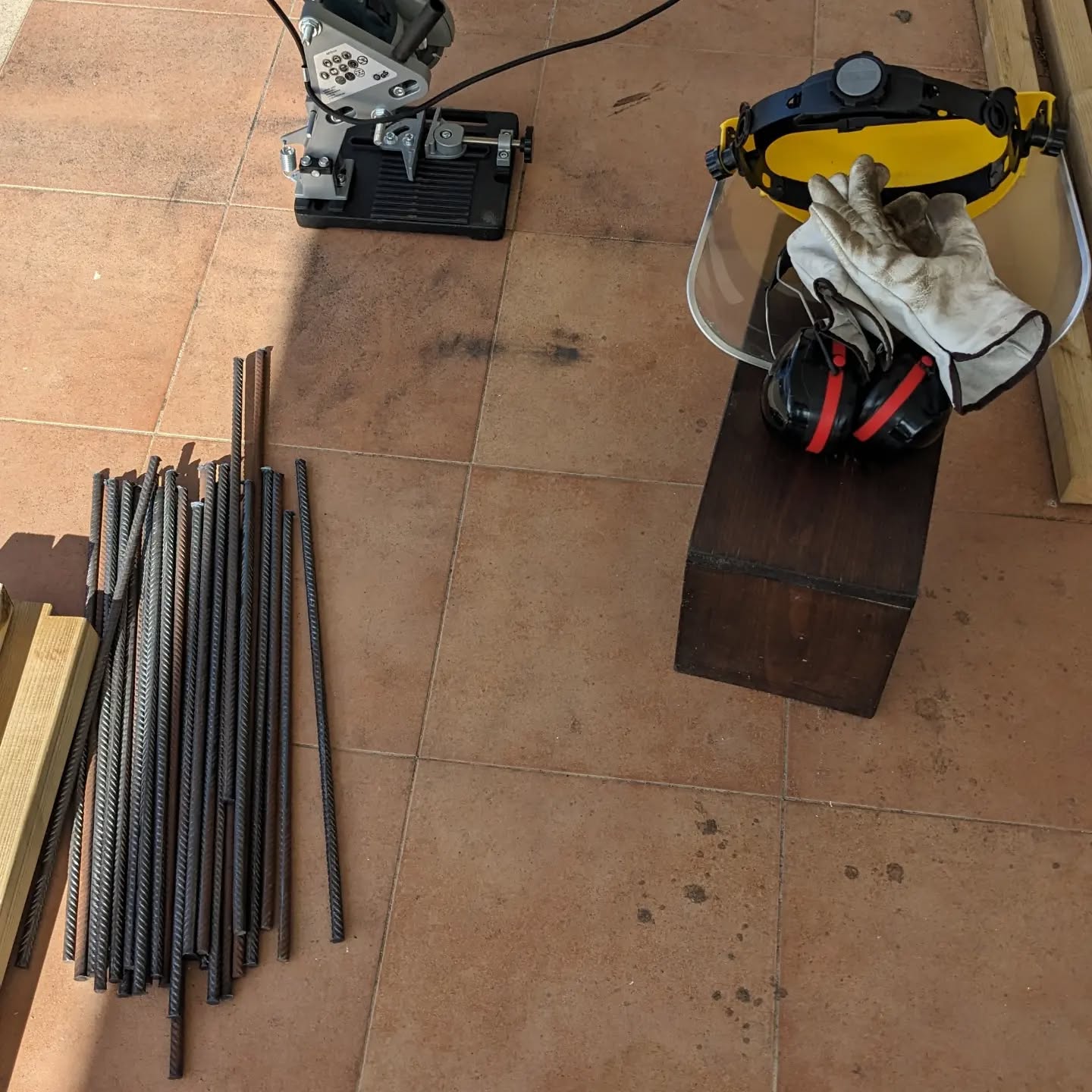 Cutting even more rebar stakes for garden beds.