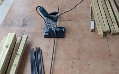 Cutting rebar stakes to make more veggie garden beds.