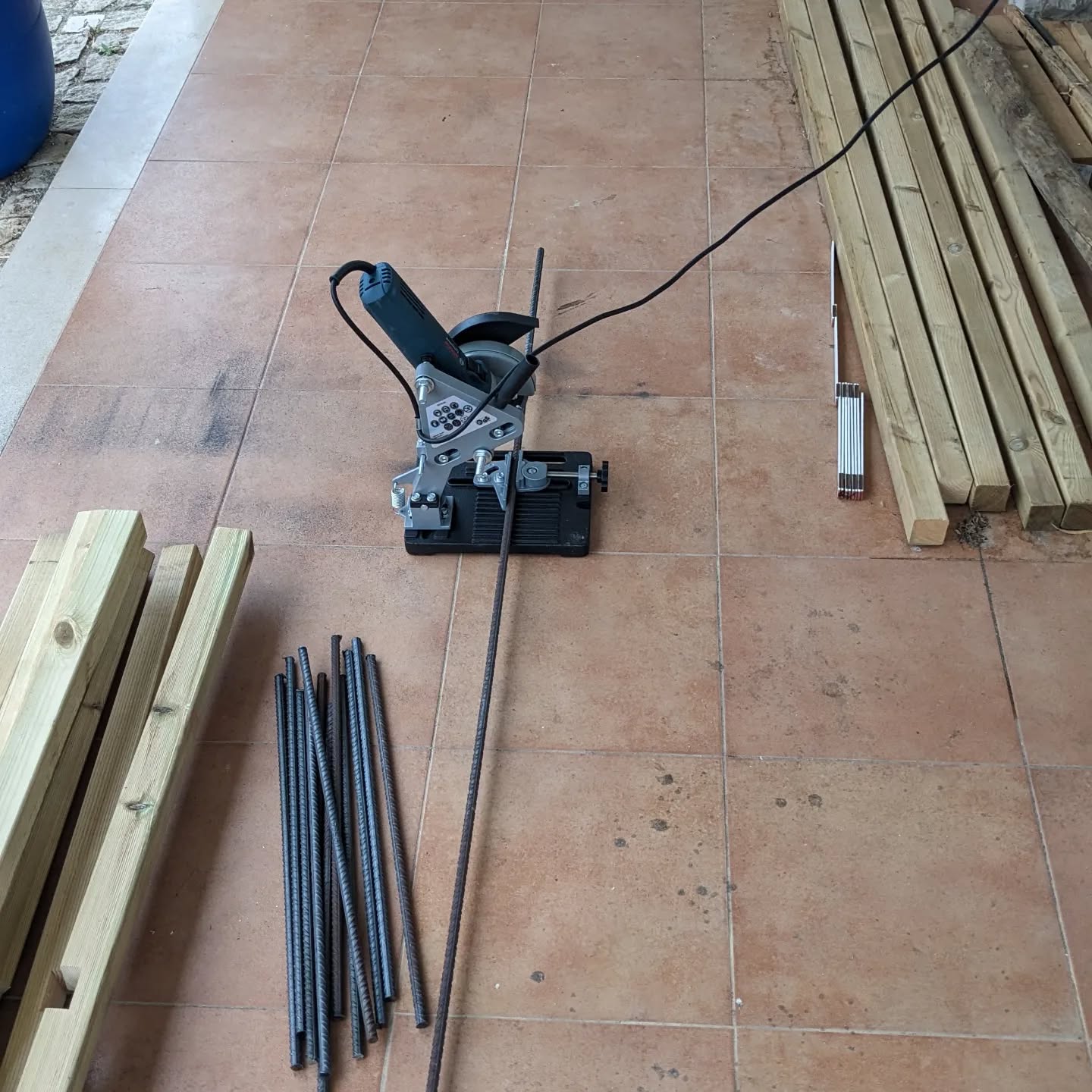Cutting rebar stakes to make more veggie garden beds.