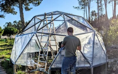Rebuilding the greenhouse cover with help from our guests.