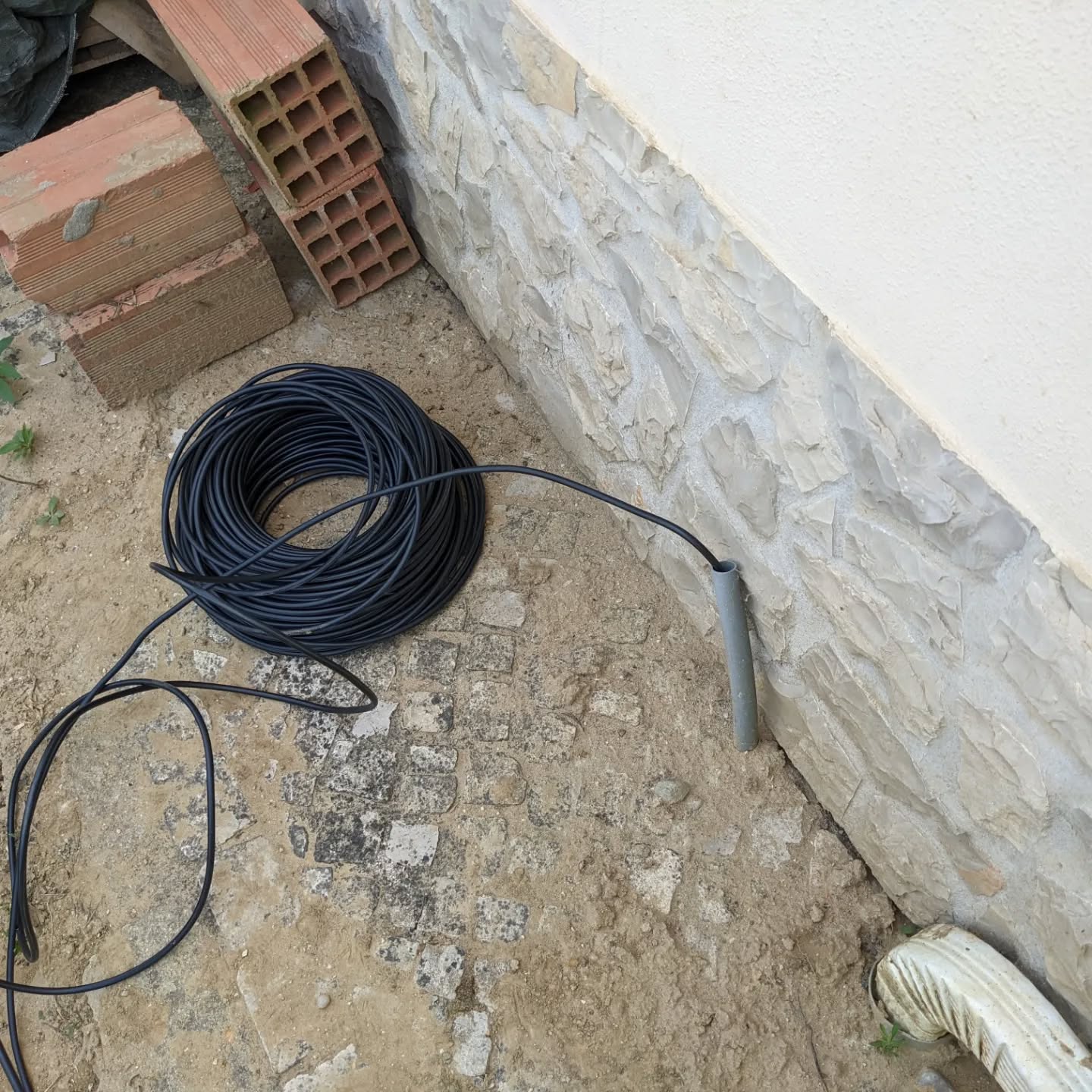 After lots of frustrating and ultimately unfruitful exploration, this seems to be the best option to run a power cable out of the churrasco to use for the irrigation controllers.